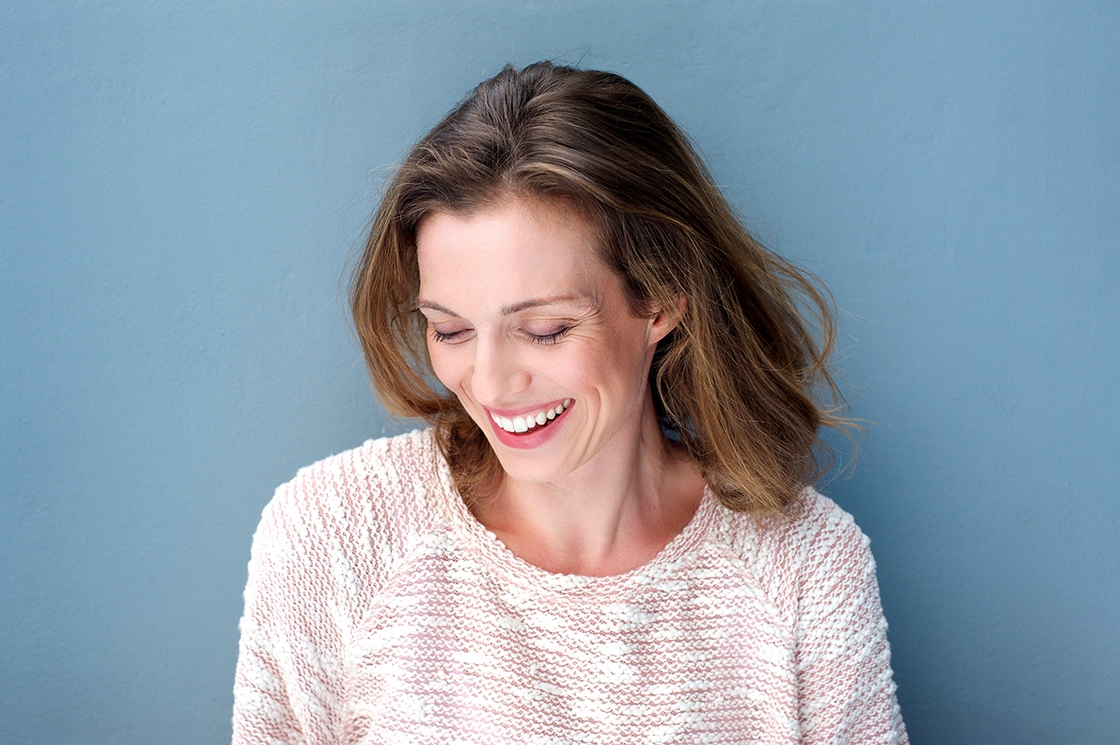 Beautiful mid adult woman laughing with sweater Beautiful mid adult woman laughing with sweater